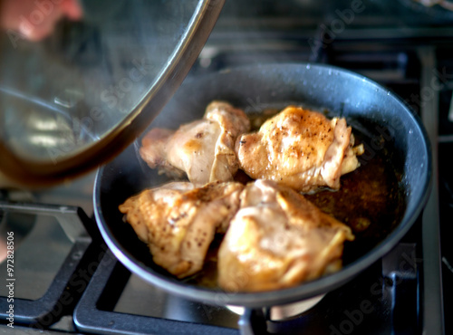 meat is fried in a frying pan in the kitchen