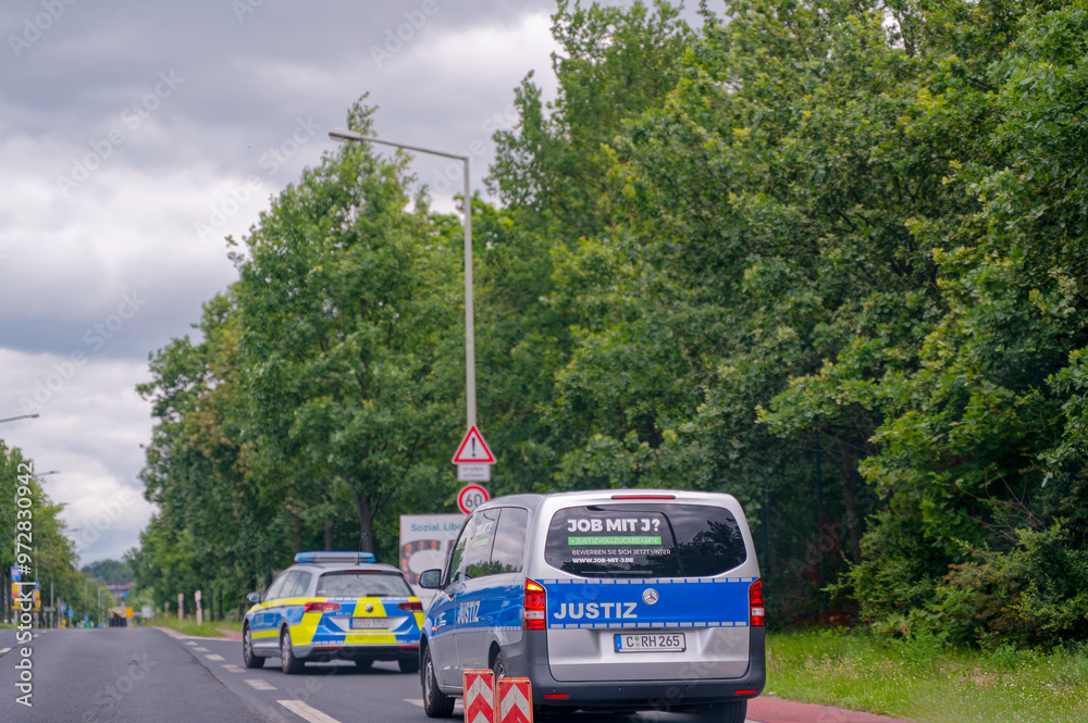 Vehicles Justice Dresden, Germany - June 11, 2024: A vehicle of justice escorted by a ...
