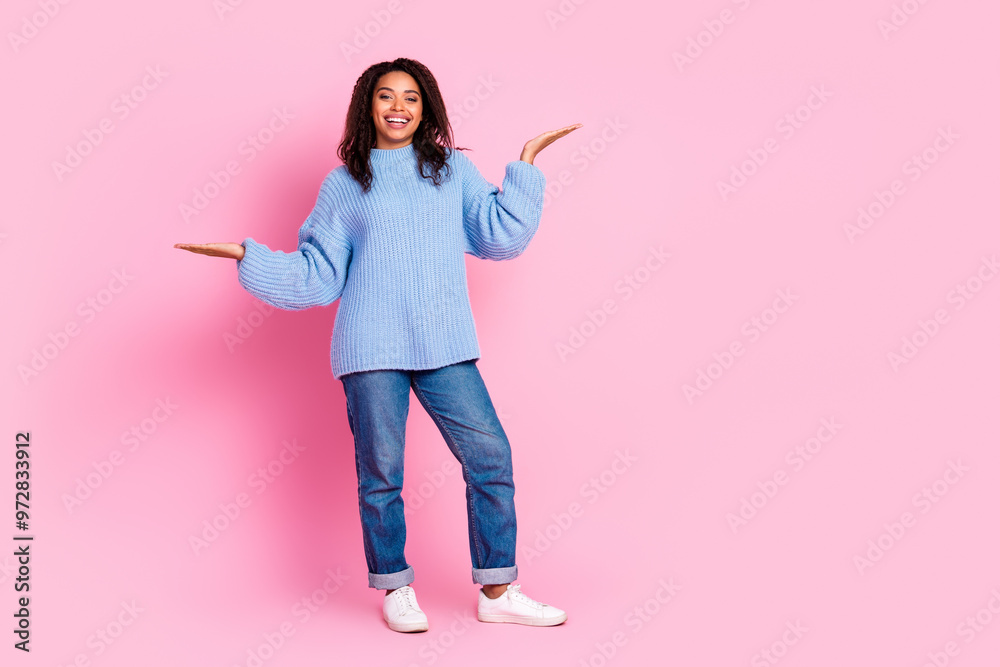 Full body portrait of nice young girl hold empty space isolated on pink color background Full body portrait of nice young girl hold empty space isolated on pink color background