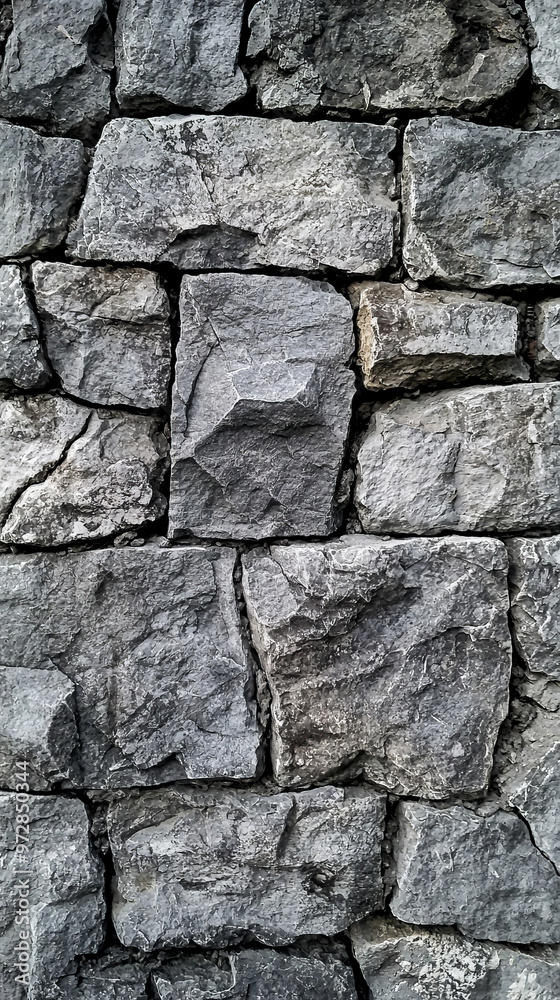 A wall made of gray stones A wall made of gray stones
