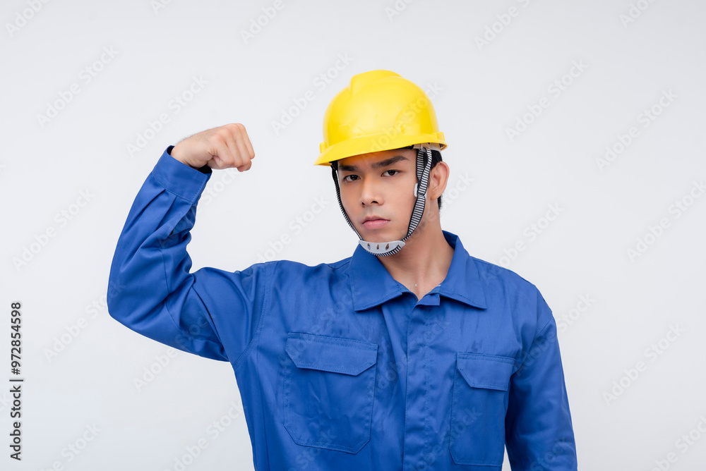 A Filipino worker flexes his bicep, showing determination and strength. Ideal for highlighting physical work, perseverance, and dedication in labor-intensive fields. A Filipino worker flexes his bicep, showing determination and strength. Ideal for highlighting physical work, perseverance, and dedication in labor-intensive fields.