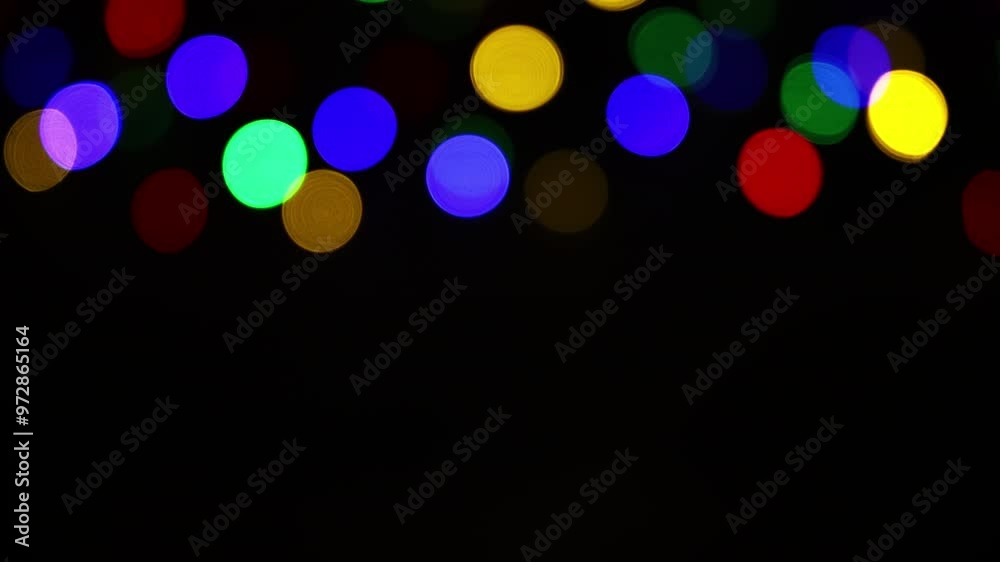 Christmas lights loop. Round colourful defocused lights. Xmas bokeh background.
