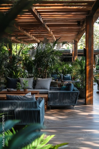 Double terrace with rustic wooden roof in a home garden with plants and flowers.