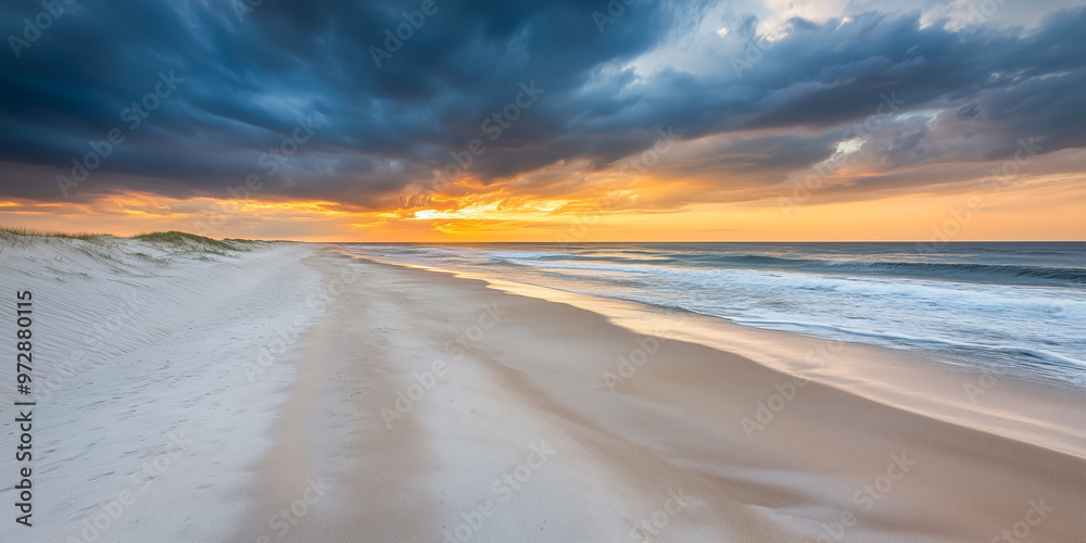 Stunning sunset over an empty beach with dramatic clouds