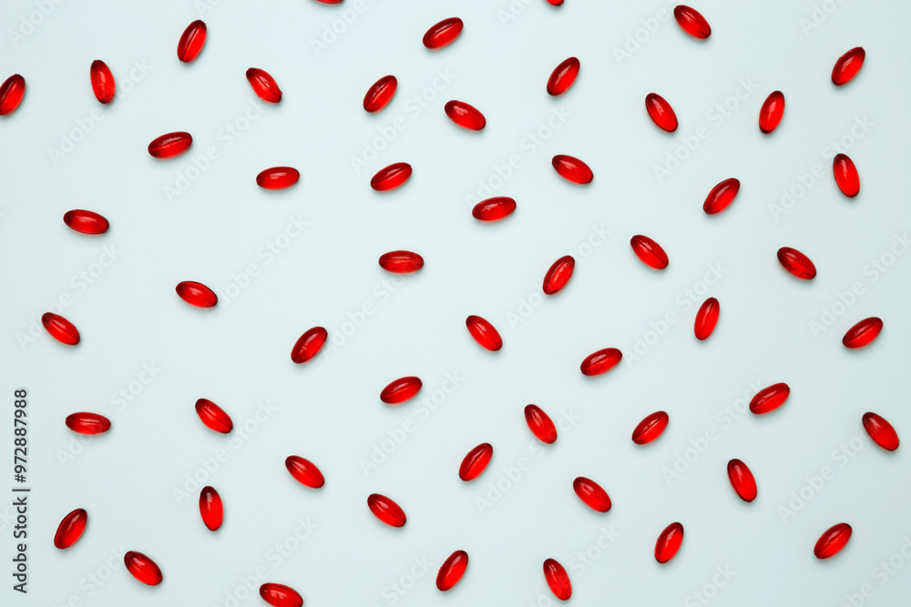 Red pills and capsules scattered. Concept of medicine, healthcare, and pharmaceutical industry Red pills and capsules scattered. Concept of medicine, healthcare, and pharmaceutical industry