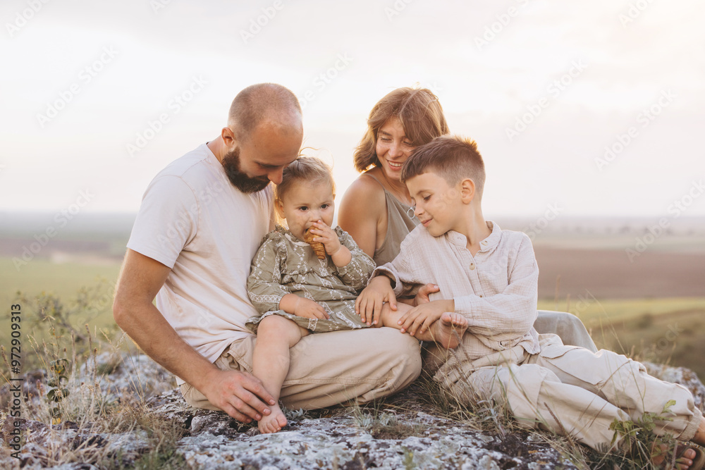 Happy Family Enjoying Quality Time Together Outdoors in a Scenic Landscape Happy Family Enjoying Quality Time Together Outdoors in a Scenic Landscape