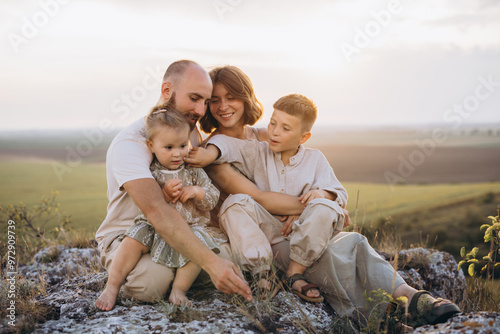 Happy Family Enjoying Time Together Outdoors on a Sunny Day at Scenic Location photo