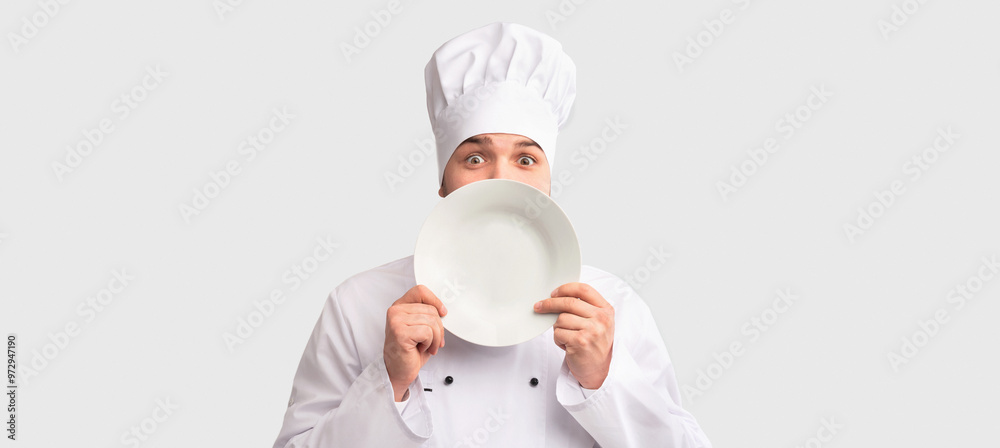 Chef Cook Man Peeking Out Holding Plate Near Face Standing Over White Studio Background. Panorama Chef Cook Man Peeking Out Holding Plate Near Face Standing Over White Studio Background. Panorama