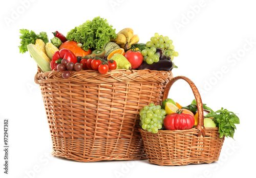 Different fresh fruits and vegetables in wicker baskets isolated on white