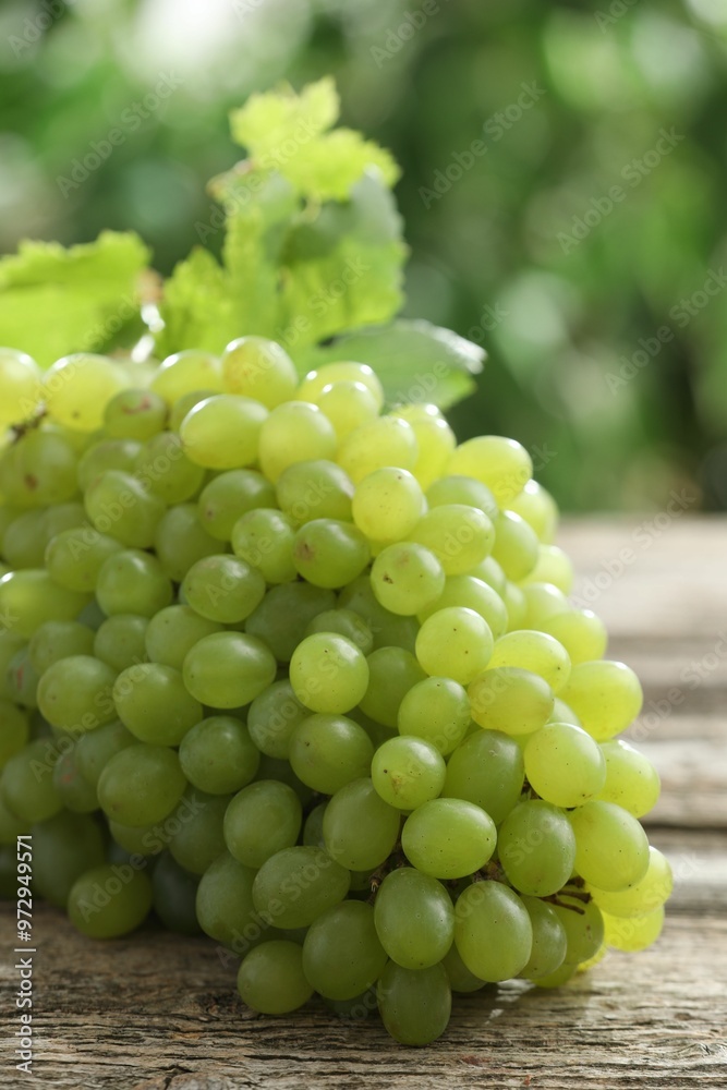 Fresh ripe grapes on wooden table, closeup Fresh ripe grapes on wooden table, closeup