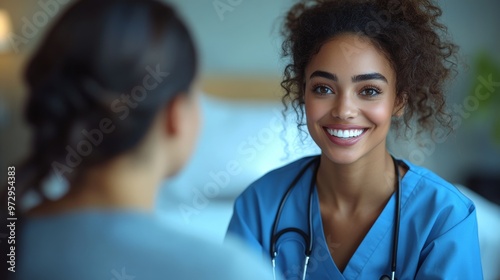 Nurse with a stethoscope smiling at a patient during a consultation in a well-lit, comfortable room setting