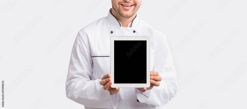 Food Delivery Application. Chef Guy Showing Tablet Screen Standing Over White Background. Studio Shot, Mockup Food Delivery Application. Chef Guy Showing Tablet Screen Standing Over White Background. Studio Shot, Mockup