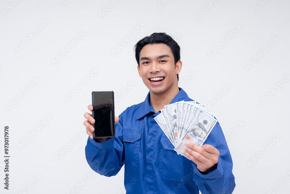 A cheerful construction worker proudly shows both cash and a smartphone, representing mobile remittances or online banking services. Ideal for digital finance or remittance platforms A cheerful construction worker proudly shows both cash and a smartphone, representing mobile remittances or online banking services. Ideal for digital finance or remittance platforms