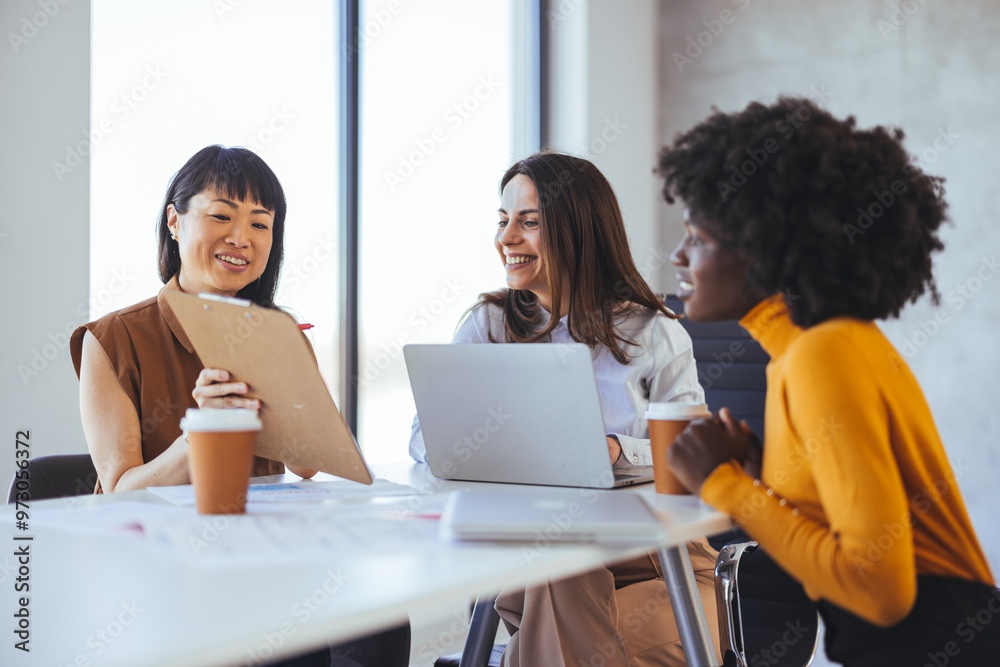 Diverse Business Team Collaborating in Modern Office Environment Diverse Business Team Collaborating in Modern Office Environment