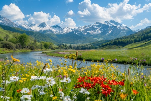 A peaceful landscape showcases a river flowing through a lush meadow adorned with vibrant wildflowers, while snow-capped mountains rise in the background under a clear blue sky.