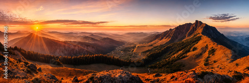 Golden sunset over a panoramic mountain landscape, with calm orange skies and tranquil atmosphere creating a peaceful and serene mood perfect for capturing the beauty of nature in a relaxing summer se