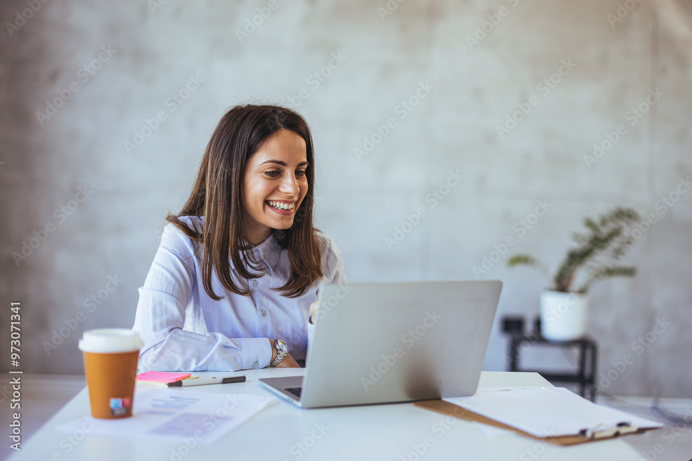Smiling Businesswoman Working on Laptop at Modern Office Smiling Businesswoman Working on Laptop at Modern Office