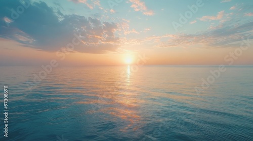 Capture the essence of a serene sunrise over an expansive ocean, where the soft colors of the sky blend with the calm water,