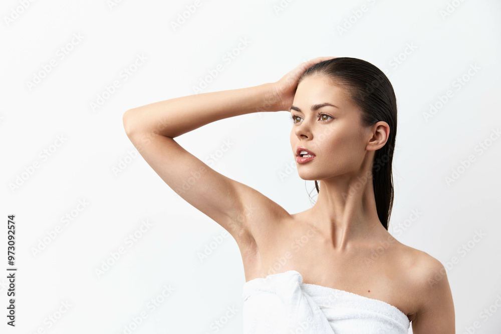 Beautiful young woman with long hair posing against a plain white background, wrapped in a towel, showcasing a fresh and natural look, emphasizing elegance and simplicity Beautiful young woman with long hair posing against a plain white background, wrapped in a towel, showcasing a fresh and natural look, emphasizing elegance and simplicity