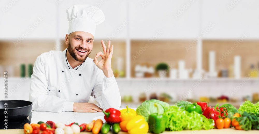 Professional Chef. Smiling Cook Man Gesturing Okay Sign Standing Next To Work Table In Restaurant Kitchen Indoor Professional Chef. Smiling Cook Man Gesturing Okay Sign Standing Next To Work Table In Restaurant Kitchen Indoor