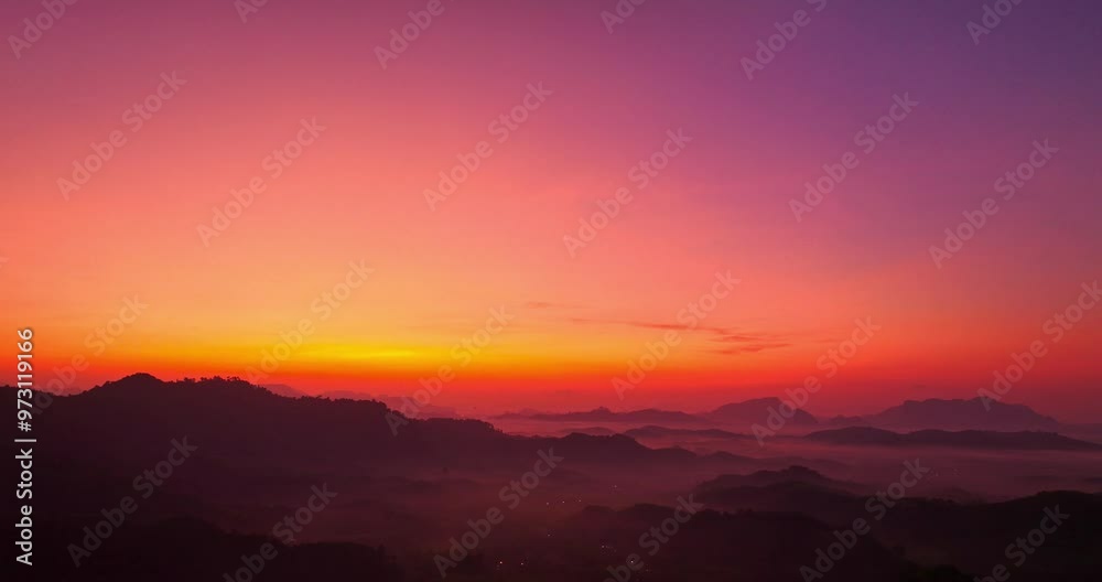 aerial view A serene landscape capturing the soft hues of dawn as mist settles over distant mountain ranges under a pastel-colored sky. Amazing pink sky at sunrise. gradient color sky texture aerial view A serene landscape capturing the soft hues of dawn as mist settles over distant mountain ranges under a pastel-colored sky. Amazing pink sky at sunrise. gradient color sky texture