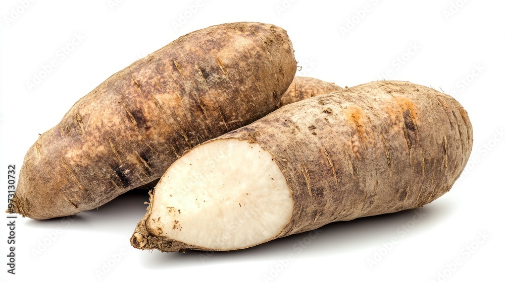 Three yams displayed, one cut in half to show its white interior. Three yams displayed, one cut in half to show its white interior.