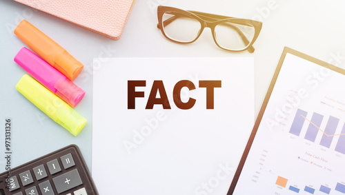 A piece of paper with the word fact written on it in bold letters. photo