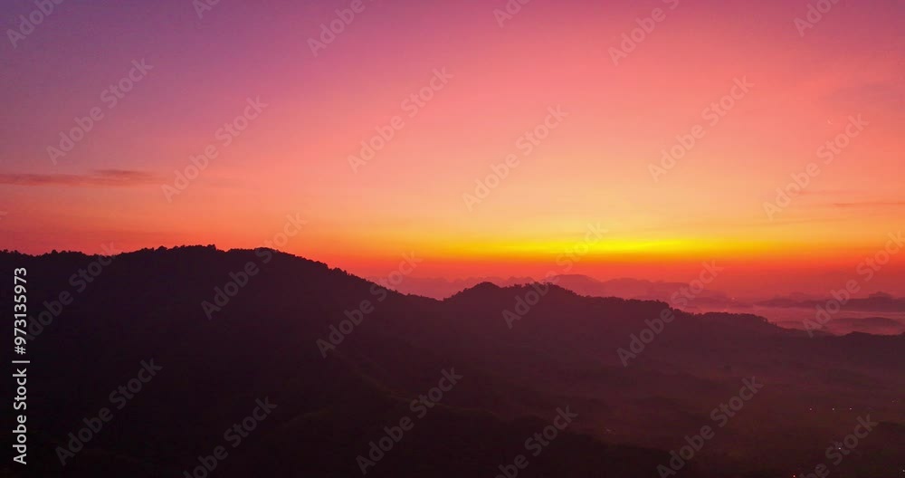 aerial view A serene landscape capturing the soft hues of dawn as mist settles over distant mountain ranges under a pastel-colored sky. Amazing pink sky at sunrise. gradient color sky texture aerial view A serene landscape capturing the soft hues of dawn as mist settles over distant mountain ranges under a pastel-colored sky. Amazing pink sky at sunrise. gradient color sky texture
