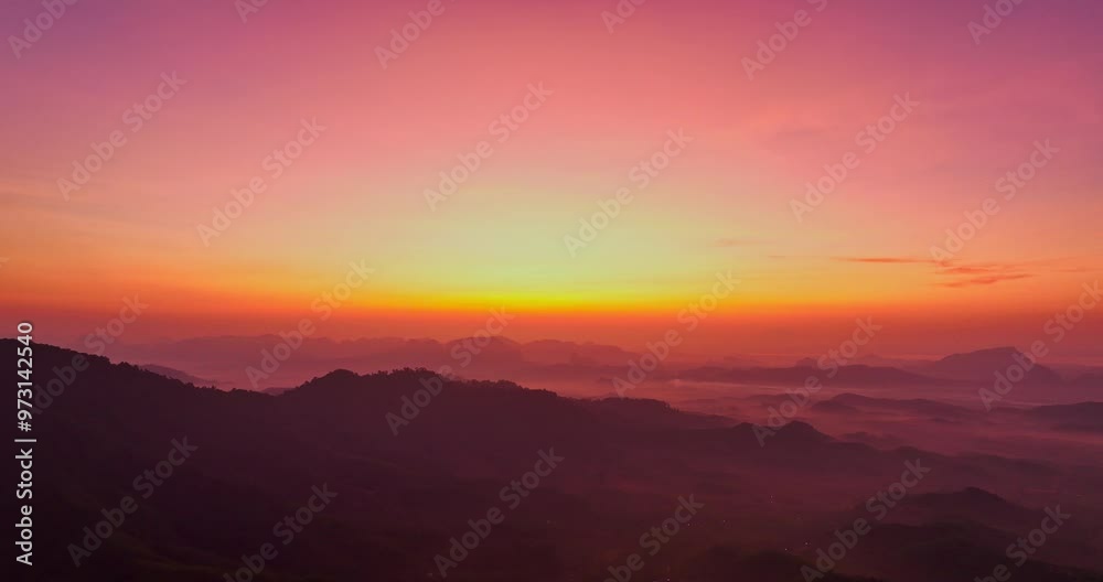 aerial view A serene landscape capturing the soft hues of dawn as mist settles over distant mountain ranges under a pastel-colored sky. Amazing pink sky at sunrise. gradient color sky texture aerial view A serene landscape capturing the soft hues of dawn as mist settles over distant mountain ranges under a pastel-colored sky. Amazing pink sky at sunrise. gradient color sky texture