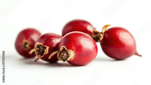 A cluster of shiny red berries arranged on a white background.