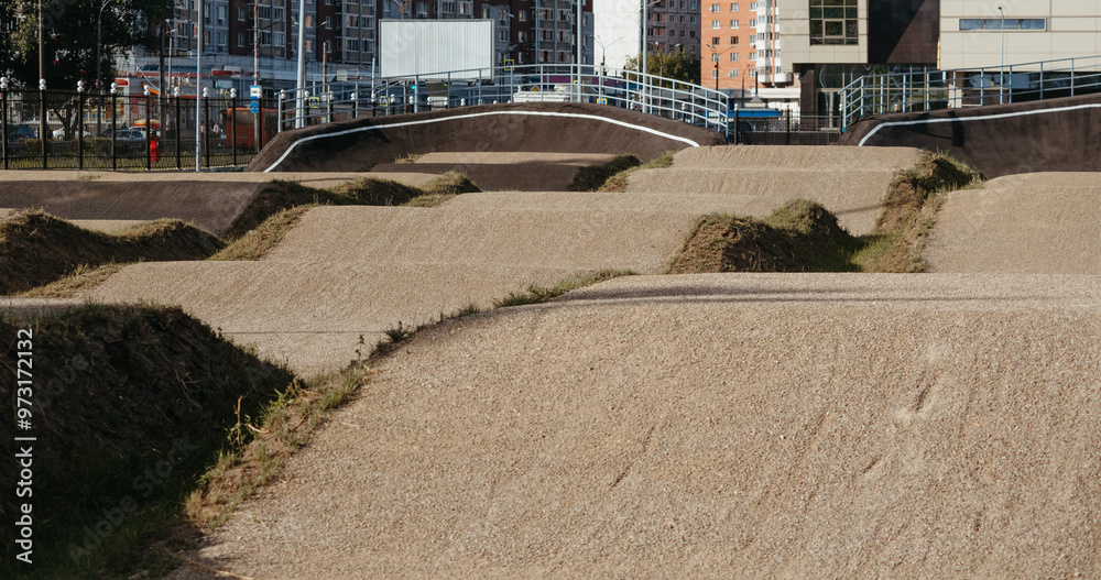 Fototapeta premium Empty BMX Race made from soil and sand. Adrenaline-Pumping Dirt BMX Race Track: A Rider's Paradise for Stunts and Speed. Extreme sport, bicycling concept