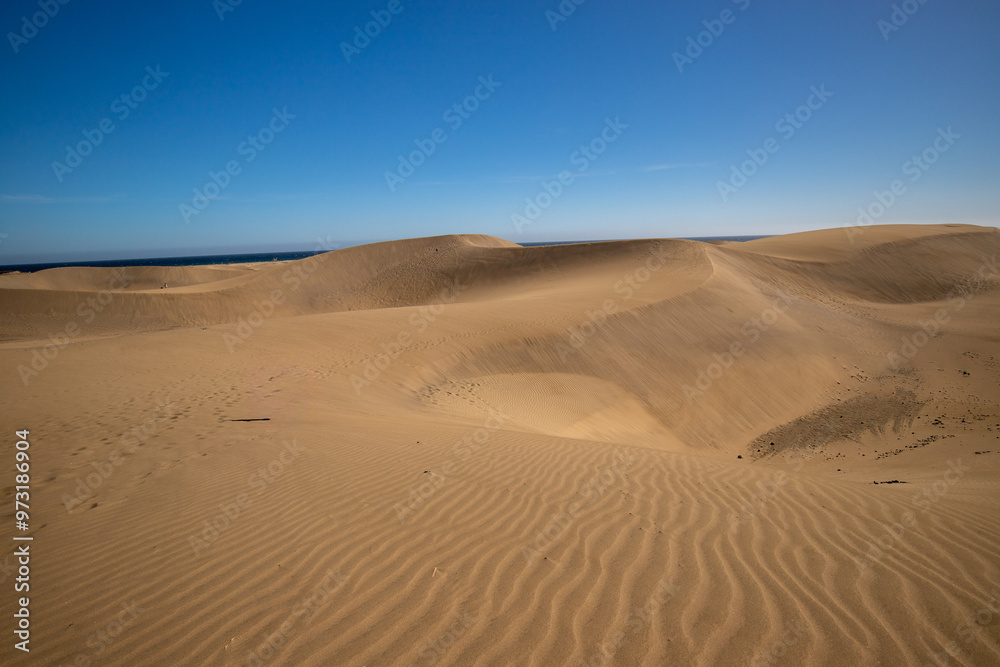 Unidentified woman walking in the Maspalomas dunes on Gran Canaria, Canary Islands, Spain Unidentified woman walking in the Maspalomas dunes on Gran Canaria, Canary Islands, Spain