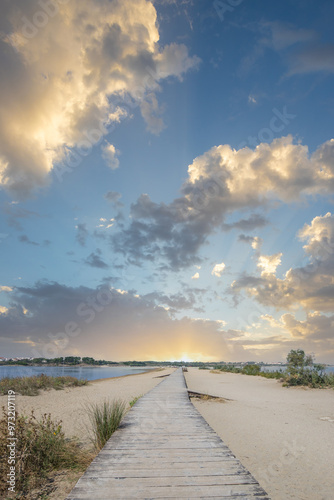 A beach surrounded by the sea on both sides. In the middle a wooden footbridge runs along the sandy beach. Natural spectacle of a Mediterranean landscape, Plaža Ždrijac, Nin, Zadar, Dalmatia, Croatia photo