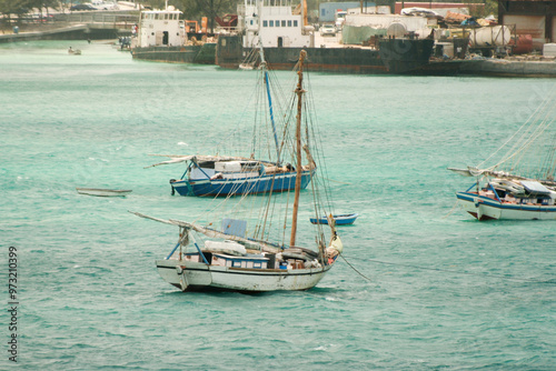 Nassau, Bahamas - April 15, 2008: Sloops are moored in the turquoise waters near the cruise port
