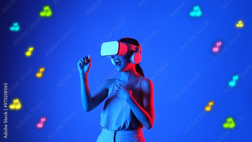 Enjoyment woman singing song wearing VR headset with graphic neon note melody musical modern design at studio dynamic lighting floating in music and technology concept blue background. Hallucination. Enjoyment woman singing song wearing VR headset with graphic neon note melody musical modern design at studio dynamic lighting floating in music and technology concept blue background. Hallucination.
