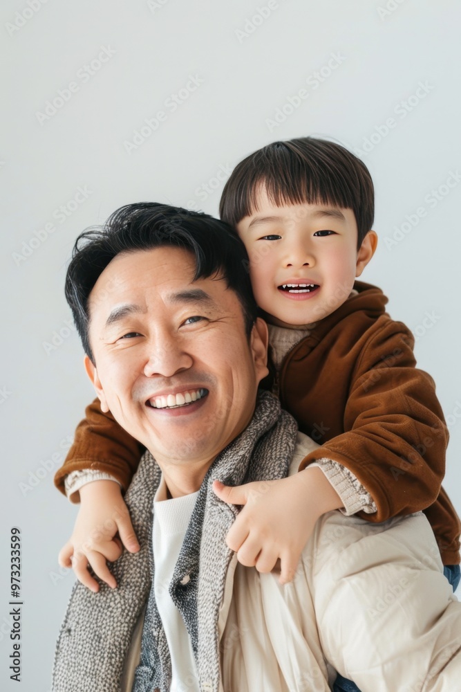 Smiling Asian Father and Son Enjoying Time Together Smiling Asian Father and Son Enjoying Time Together