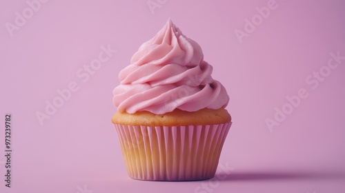 A beautifully swirled pink frosted cupcake on a pastel pink background, showcasing a delightful dessert perfect for celebrations or sweets lovers