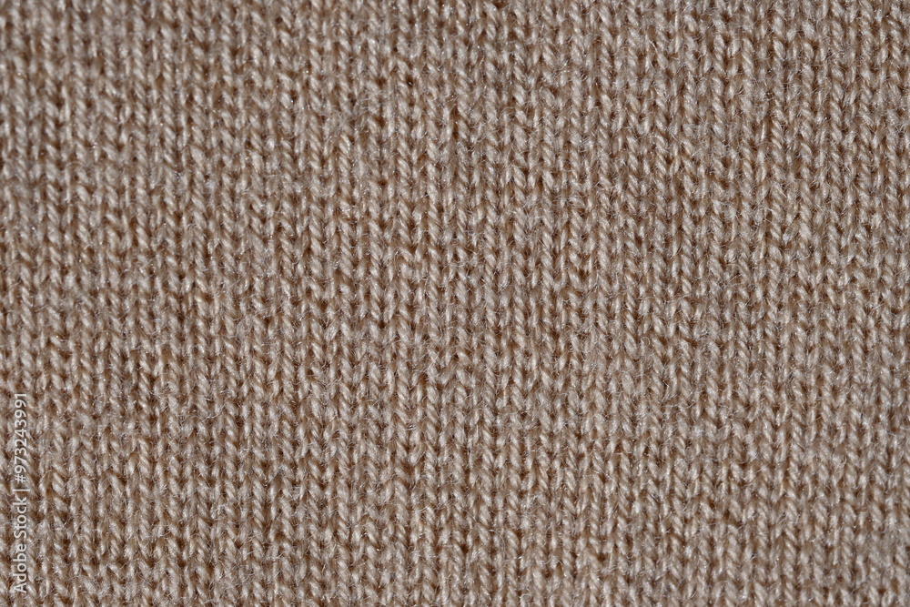 brown texture of knitted wool fabric as a background, smooth symmetrical lines of hand-knitted needlework pattern brown texture of knitted wool fabric as a background, smooth symmetrical lines of hand-knitted needlework pattern