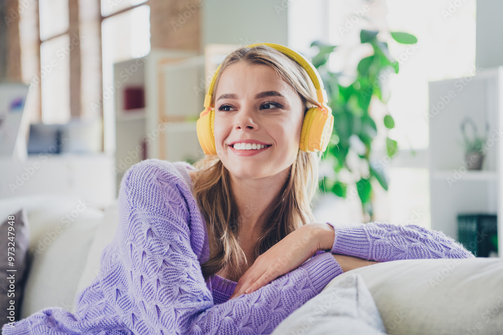 Photo of nice young girl sit couch headphones listen music look empty space wear violet clothes modern cozy interior flat indoors Photo of nice young girl sit couch headphones listen music look empty space wear violet clothes modern cozy interior flat indoors