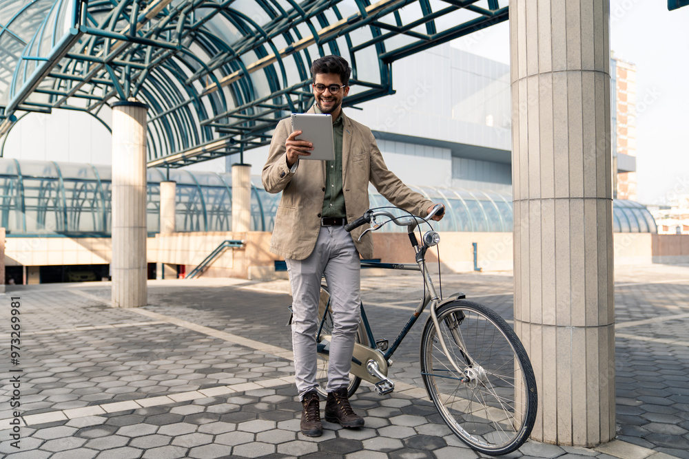 Smiling Businessman with Bicycle Using Tablet Outdoors Smiling Businessman with Bicycle Using Tablet Outdoors