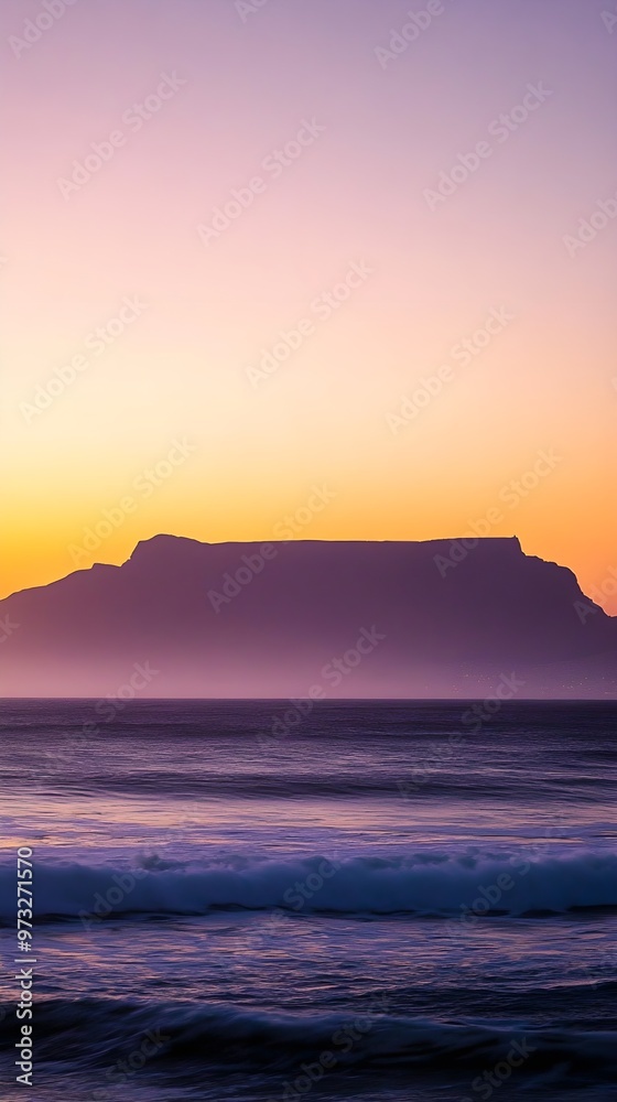 A sunset silhouette of Table Mountain, casting dramatic shadows against a soft pastel background A sunset silhouette of Table Mountain, casting dramatic shadows against a soft pastel background