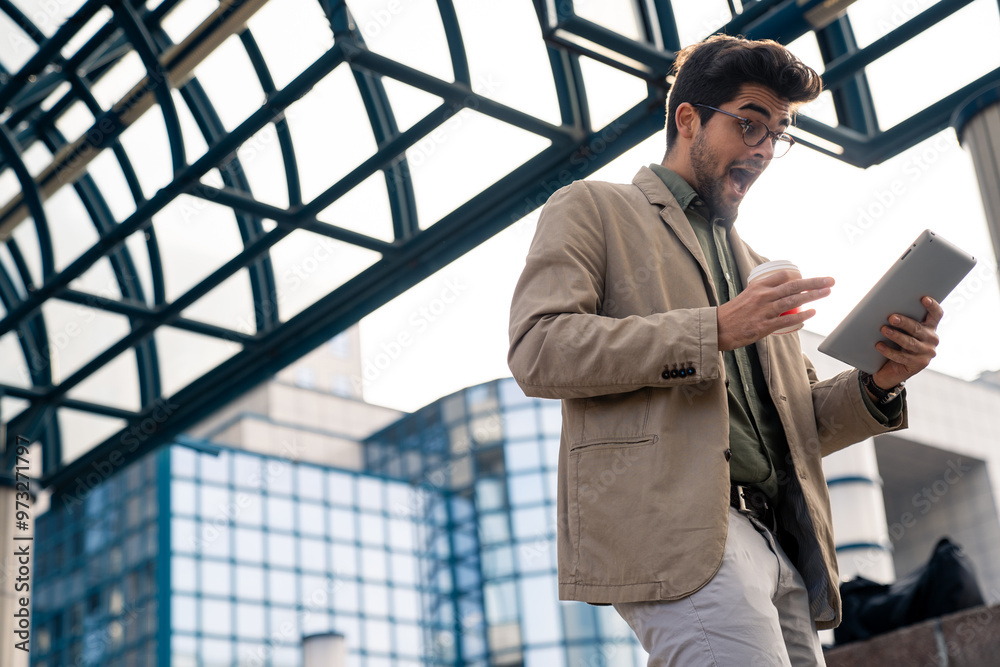 Engaged Businessman with Tablet and Coffee Outdoors Engaged Businessman with Tablet and Coffee Outdoors