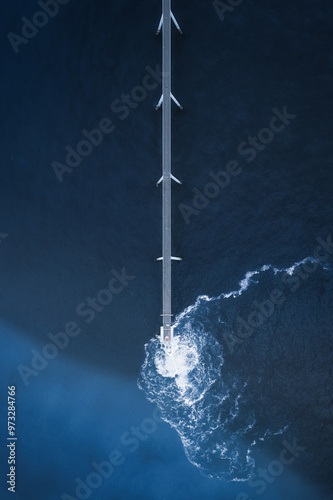 Aerial view of blue ocean and a sewage treatment plant on the sea