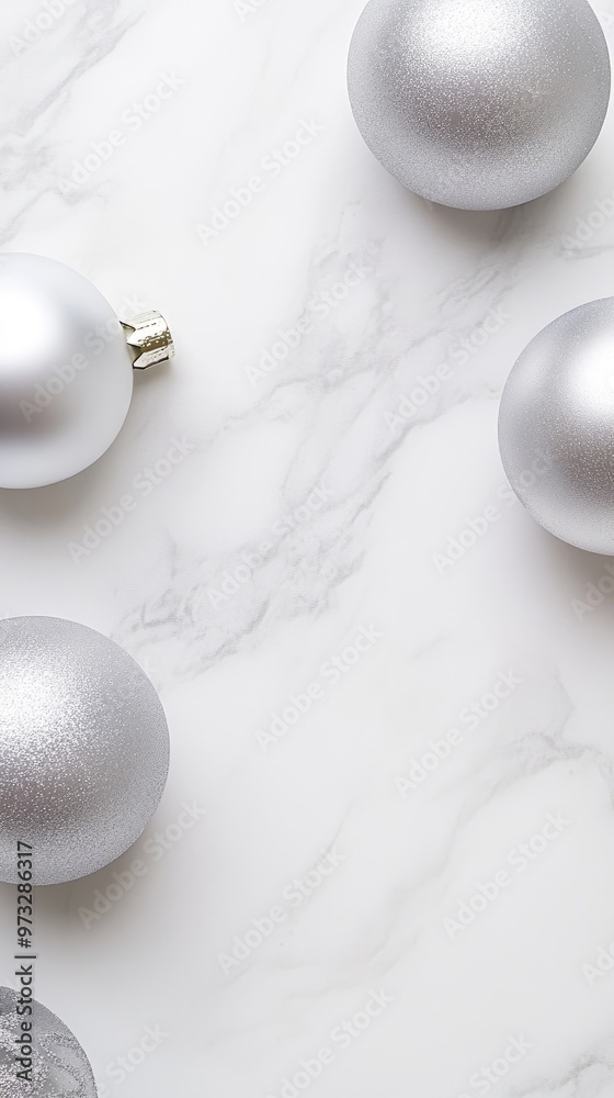 Five delicate glass ornaments in silver and white, adorned with lace patterns, rest on a marble surface, illuminated by soft lighting and complemented by light fabric and greenery. Five delicate glass ornaments in silver and white, adorned with lace patterns, rest on a marble surface, illuminated by soft lighting and complemented by light fabric and greenery.