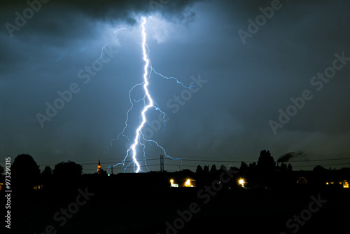 Tele photo of a distant branched lightning bolt at night, more than 50 kilometers away