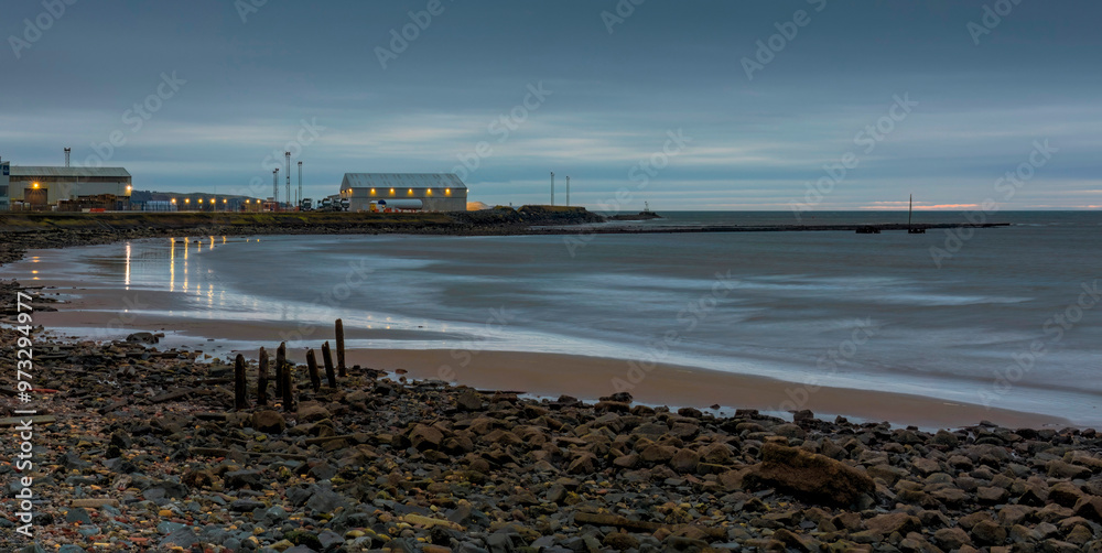 Ayr Harbour building after sunset with lights reflecting in sea water and wreck of MV Kaffir Ayr Harbour building after sunset with lights reflecting in sea water and wreck of MV Kaffir