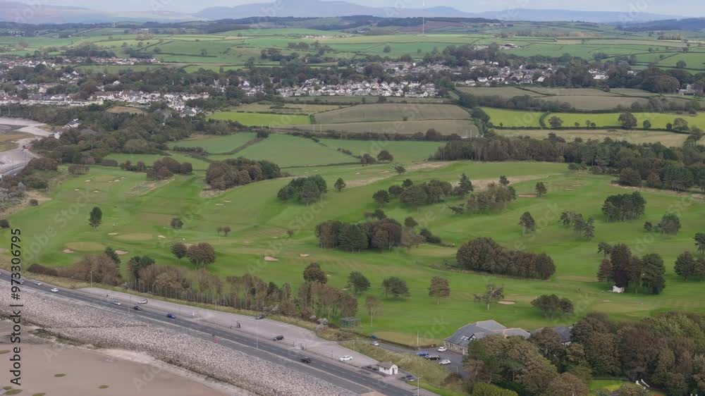 Aerial view of golf course in the United Kingdom next to a beach. Sports and recreation concept Aerial view of golf course in the United Kingdom next to a beach. Sports and recreation concept