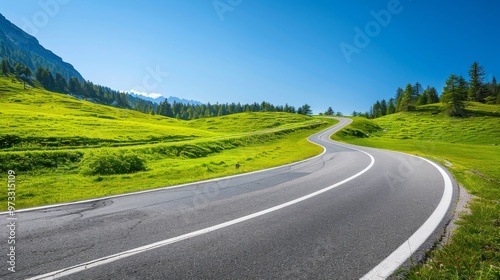 Winding asphalt road through green Alpine meadows, clear blue sky, Close-up photo with clean background photo