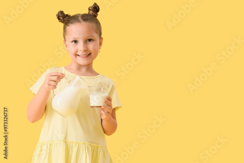 Cute little girl with jug a...