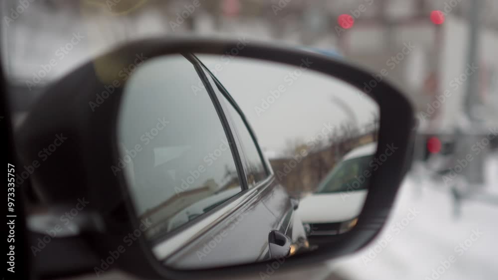 side rearview mirror reflects the view of the city and cars, the view from inside the car. side rearview mirror reflects the view of the city and cars, the view from inside the car.
